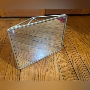 Mirror with geometric metalwork